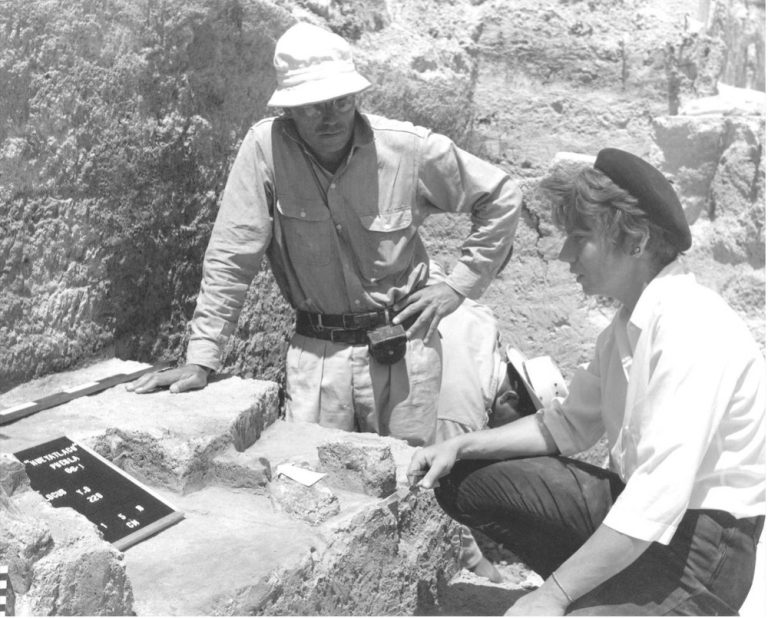 Archeologists in a black and white image.
